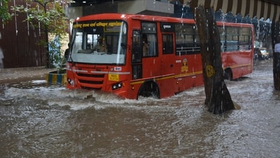 A public bus wades through a waterlogged road in Mumbai amid heavy rain in the city. (Praful Gangurde/Hindustan Times)