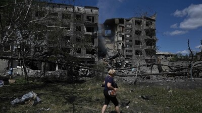 A woman walks past a heavily damaged residential building following a Russian strike in the town of Bilozerske, Donetsk region in Ukraine. (AFP) A woman walks past a heavily damaged residential building following a Russian strike in the town of Bilozerske, Donetsk region in Ukraine. (AFP)