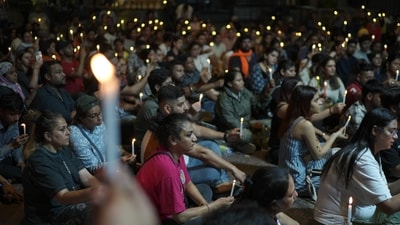 Animal lovers hold candlelight vigil as they protest against the recent order by the Supreme Court directing authorities in Delhi-NCR to start relocating all stray dogs from streets to shelters, at Connaught Place, in New Delhi on August 19, 2025. (PTI)