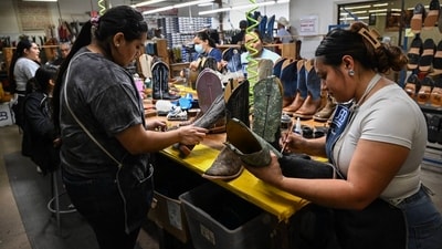 Workers at a cowboy boot factory put the finishing touches on boots in Mercedes, Texas, July 31. Workers at a cowboy boot factory put the finishing touches on boots in Mercedes, Texas, July 31.