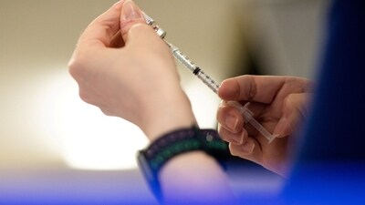A nurse fills a syringe with a Covid vaccine in Waterford, Mich., April 8, 2022.