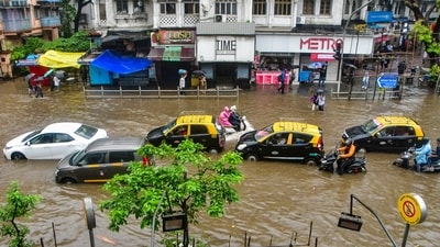Mumbai rains: Commuters wade through a waterlogged road in Dadar TT area (PTI) Mumbai rains: Commuters wade through a waterlogged road in Dadar TT area (PTI)
