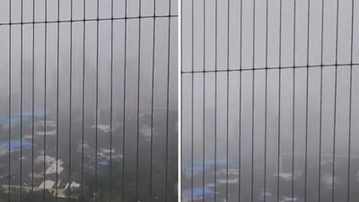 Filmed from a balcony, the clip showed torrential rain engulfing the skyline in a dense, cloudy haze. (X/@viraldharod)
