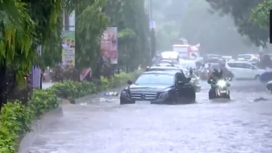 A video from Mumbai's Andheri West shows a Mercedes on a waterlogged road. (ANI)