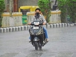 Caught unawares, commuters make their way amid rain in Ludhiana on Wednesday. (Manish/HT) Caught unawares, commuters make their way amid rain in Ludhiana on Wednesday. (Manish/HT)