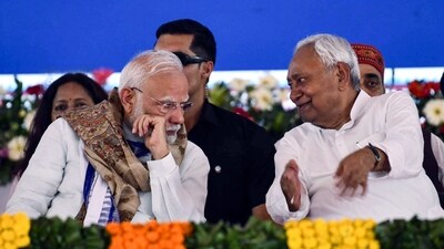 Prime Minister Narendra Modi in conversation with Bihar CM Nitish Kumar during a public meeting in Motihari. (ANI File)