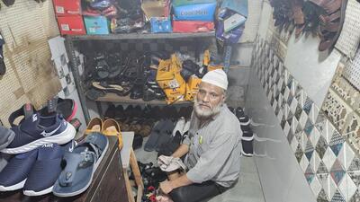 Insaaf Khan, who owns a small shoe shop in Prem Nagar, was seated on the floor, wiping his stock of shoes with a clean cloth and keeping them out to dry. (Photo by Sabah Virani) Insaaf Khan, who owns a small shoe shop in Prem Nagar, was seated on the floor, wiping his stock of shoes with a clean cloth and keeping them out to dry. (Photo by Sabah Virani)