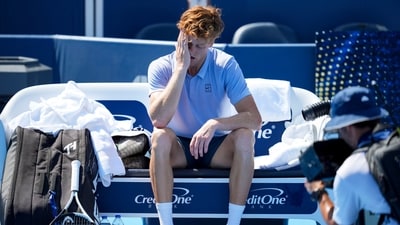 Jannik Sinner (ITA) sits on his bench after retiring from his match against Carlos Alcaraz (ESP) during the Cincinnati Open (IMAGN IMAGES via Reuters Connect)