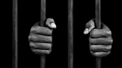 hands of a prisoner on prison bars (Getty Images/Vetta) hands of a prisoner on prison bars (Getty Images/Vetta)