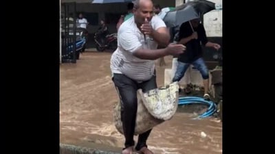 Completely drenched, the man dances freely and joyfully before diving into the flooded street. (X/@Madan_Chikna)