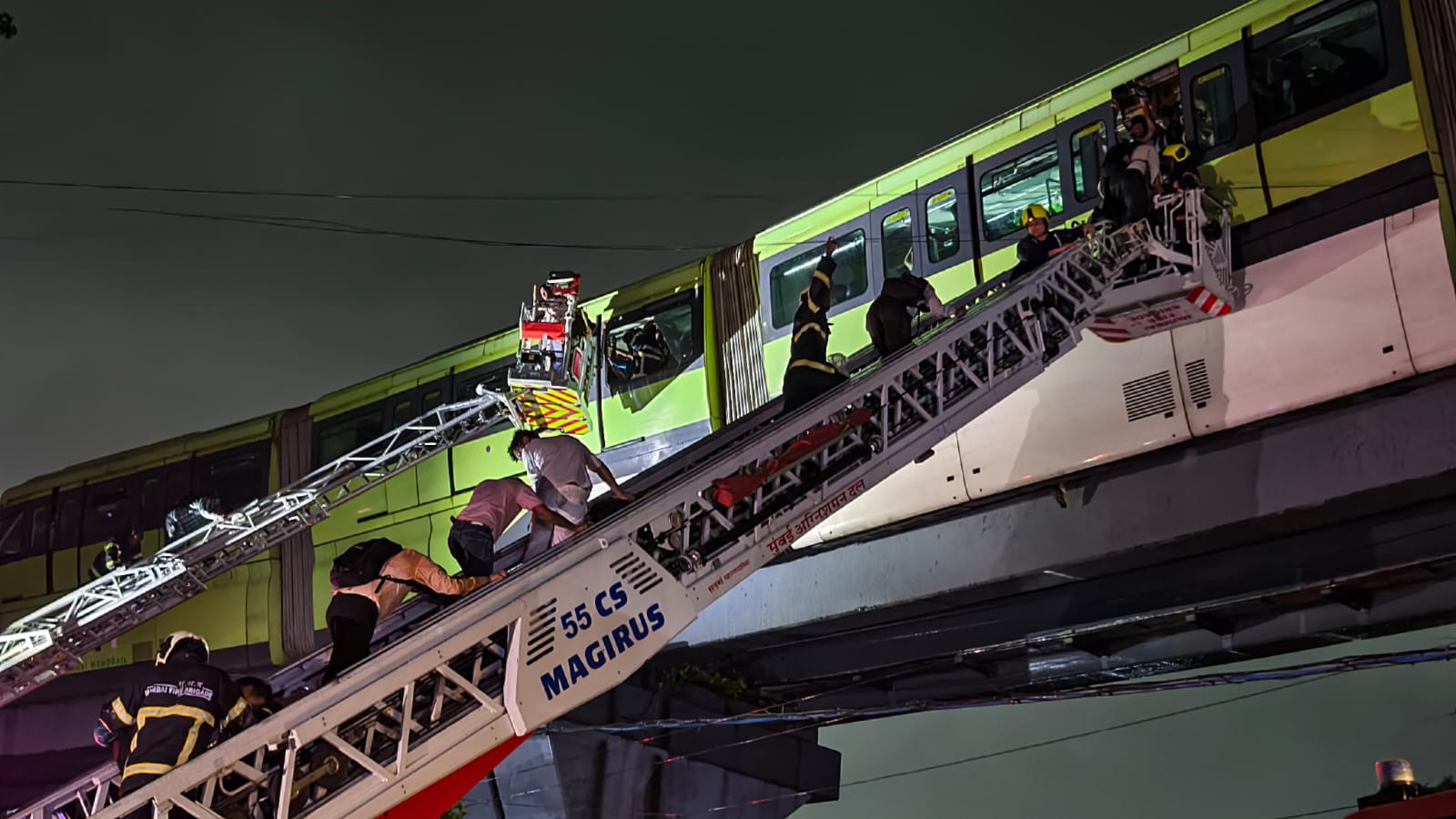 Passengers being rescued after a Monorail train came to a halt between Mysore Colony and Bhakti Park stations due to apparent power failure during rainfall in Mumbai on Tuesday evening. (Raju Shinde/HT Photo) Passengers being rescued after a Monorail train came to a halt between Mysore Colony and Bhakti Park stations due to apparent power failure during rainfall in Mumbai on Tuesday evening. (Raju Shinde/HT Photo)