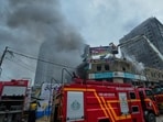 Broken glass from nearby shop windows littered the road as panicked residents rushed from the scene, witnesses said. Broken glass from nearby shop windows littered the road as panicked residents rushed from the scene, witnesses said.