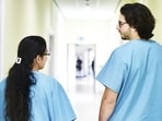 Colleagues walking down the hospital corridor Colleagues walking down the hospital corridor