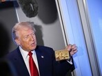 US President Donald Trump holds the $5 million dollar Gold Card as he speaks to reporters while in flight on board Air Force One US President Donald Trump holds the $5 million dollar Gold Card as he speaks to reporters while in flight on board Air Force One