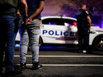 An ICE agent and a handcuffed man after a recent traffic stop in Washington, D.C.