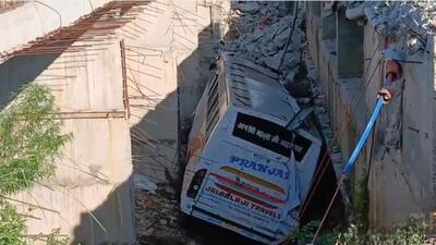 The bus carrying pilgrims to the Vaishno Devi shrine after skidding off a bridge on the Jammu-Pathankot highway in Samba district on Thursday. (HT Photo)