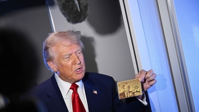 US President Donald Trump holds the $5 million dollar Gold Card as he speaks to reporters while in flight on board Air Force One (AFP) US President Donald Trump holds the $5 million dollar Gold Card as he speaks to reporters while in flight on board Air Force One (AFP)