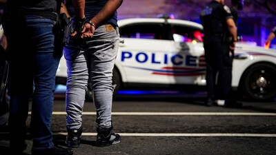 An ICE agent and a handcuffed man after a recent traffic stop in Washington, D.C. An ICE agent and a handcuffed man after a recent traffic stop in Washington, D.C.