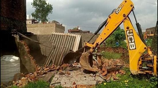 Bulldozers were deployed to raze unauthorised constructions where colonisers were attempting illegal plotting. (HT Photo)