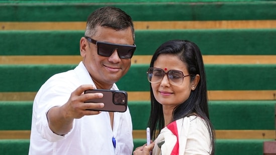 TMC MP Mahua Moitra and BJP MP Brijesh Chowta take a selfie outside the Parliament, as the monsoon session wraps up on Thursday.(Ravi Choudhary/PTI)