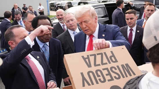 Speaking to the federal agents who will be patrolling the streets of DC, Donald Trump said that he would eat with them, and that they would have a ‘little fun’. (AP)