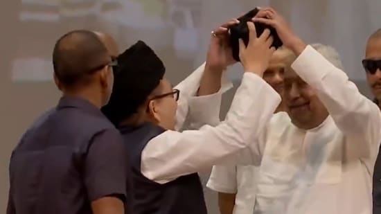 Bihar CM Nitish Kumar resisted with a smile and both hands as a Muslim community leader offered to put a cap on his head, at the state madrasa education board's function in Patna. (X/ANI)