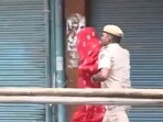 A Delhi Police constable is seen dispersing the ruckus at Chief Minister Rekha Gupta's event in the Gandhi Nagar area of the city. A Delhi Police constable is seen dispersing the ruckus at Chief Minister Rekha Gupta's event in the Gandhi Nagar area of the city.