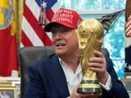 US President Donald Trump holds the World Cup trophy in the Oval Office of the White House in Washington, DC, on August 22, 2025. Trump announced the 2026 World Cup draw will be held on December 5 at Washington's Kennedy Center. (Photo by ANDREW CABALLERO-REYNOLDS / AFP) US President Donald Trump holds the World Cup trophy in the Oval Office of the White House in Washington, DC, on August 22, 2025. Trump announced the 2026 World Cup draw will be held on December 5 at Washington's Kennedy Center. (Photo by ANDREW CABALLERO-REYNOLDS / AFP)