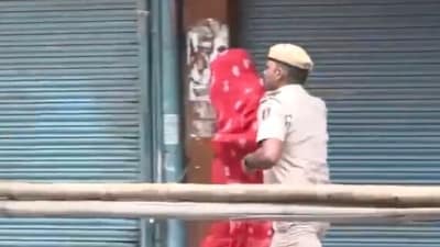 A Delhi Police constable is seen dispersing the ruckus at Chief Minister Rekha Gupta's event in the Gandhi Nagar area of the city. (ANI)