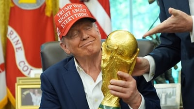 President Donald Trump holds the FIFA World Cup Winners Trophy during an announcement in the Oval Office (AP) President Donald Trump holds the FIFA World Cup Winners Trophy during an announcement in the Oval Office (AP)