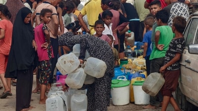 Palestinians queue to fill up on drinking water in the sweltering heat in the Mawasi area of Khan Yunis in the southern Gaza Strip on August 12, 2025. (AFP) Palestinians queue to fill up on drinking water in the sweltering heat in the Mawasi area of Khan Yunis in the southern Gaza Strip on August 12, 2025. (AFP)