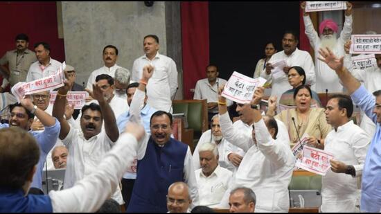 Congress MLAs protesting against the deteriorating law and order situation in Haryana on the opening day of the monsoon session of the assembly in Chandigarh on Friday. (Keshav Singh/HT)