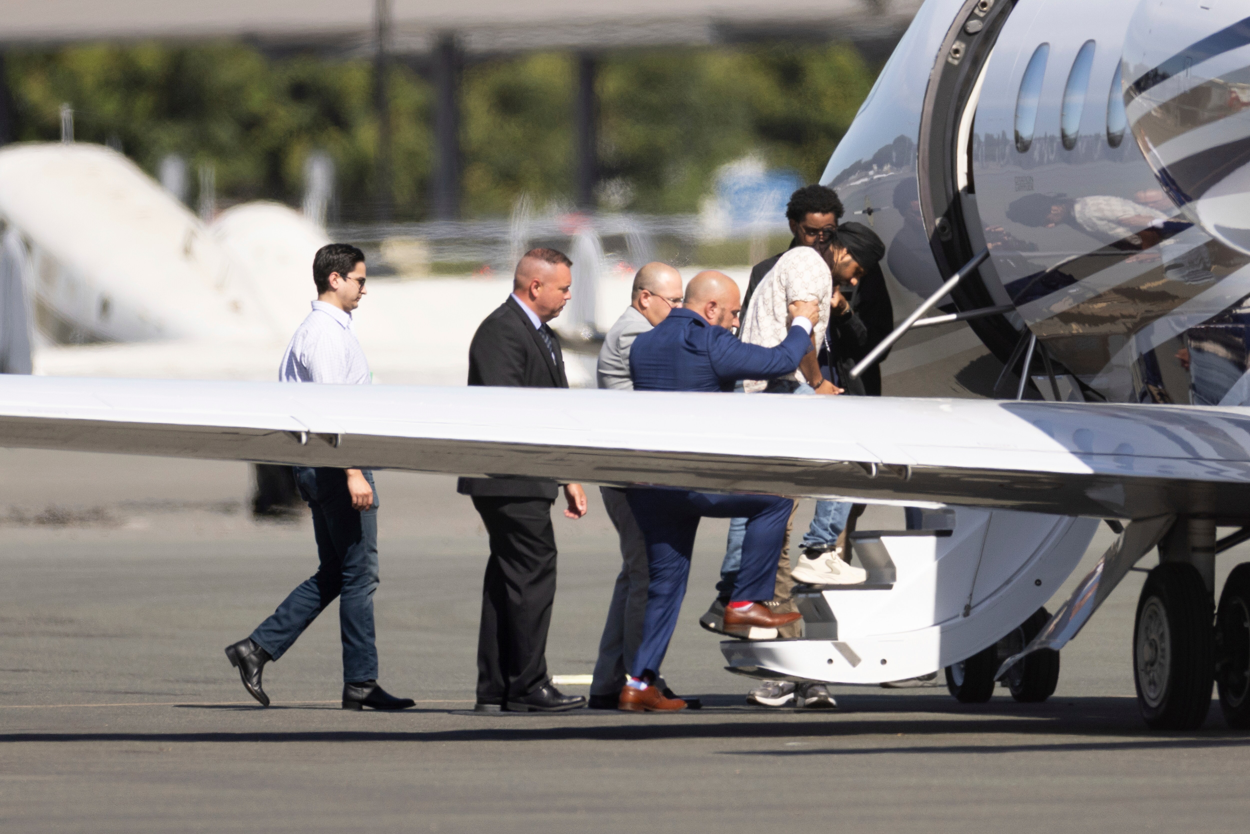 Harjinder Singh is escorted onto an airplane by Florida Lt. Gov. Jay Collins and law enforcement on Thursday in Stockton. (AP) Harjinder Singh is escorted onto an airplane by Florida Lt. Gov. Jay Collins and law enforcement on Thursday in Stockton. (AP)