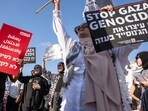 Israeli and Palestinian activists take part in a protest calling for the end of the war and an end to starvation in the Gaza Strip, as they gather in Tel Aviv, Israel, Aug. 23, 2025