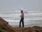 A man stands on a beach, following the passage of Erin, the first hurricane of the 2025 Atlantic season.