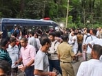 People gather near a site of an alleged burial related to the Dharmasthala mass burial case, at Dharmasthala, in Dakshina Kannada district.