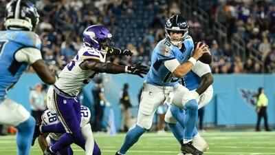 Tennessee Titans wide receiver Mason Kinsey (12) scrambles out of the grasp of Minnesota Vikings linebacker Austin Keys (56) during the second half at Nissan Stadium. Mandatory Credit: Steve Roberts-Imagn Images (IMAGN IMAGES via Reuters Connect)