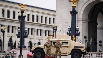 Members of the National Guard stand near a Humvee outside of Union Station (REUTERS)
