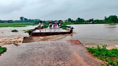 People stand near the part of a local bridge that was washed away following heavy rainfall, disrupting local connectivity, in Latehar district of Jharkhand (PTI) People stand near the part of a local bridge that was washed away following heavy rainfall, disrupting local connectivity, in Latehar district of Jharkhand (PTI)
