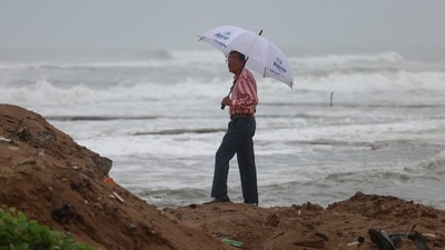 A man stands on a beach, following the passage of Erin, the first hurricane of the 2025 Atlantic season. (REUTERS)