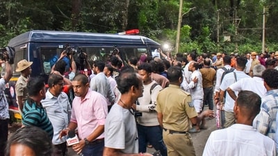 People gather near a site of an alleged burial related to the Dharmasthala mass burial case, at Dharmasthala, in Dakshina Kannada district. (PTI)