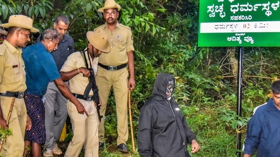 The complainant (in the mask), who is a former sanitation worker, claimed that he had worked in Dharmasthala between 1995 and 2014. (PTI)