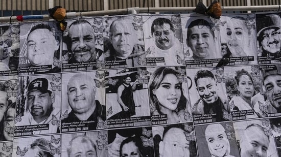 An art installation, which displays black and white images of people detained or deported as a result of ICE raids in Southern California, stands outside the federal building in Los Angeles, Thursday, July 17, 2025. (AP Photo/Jae C. Hong)
