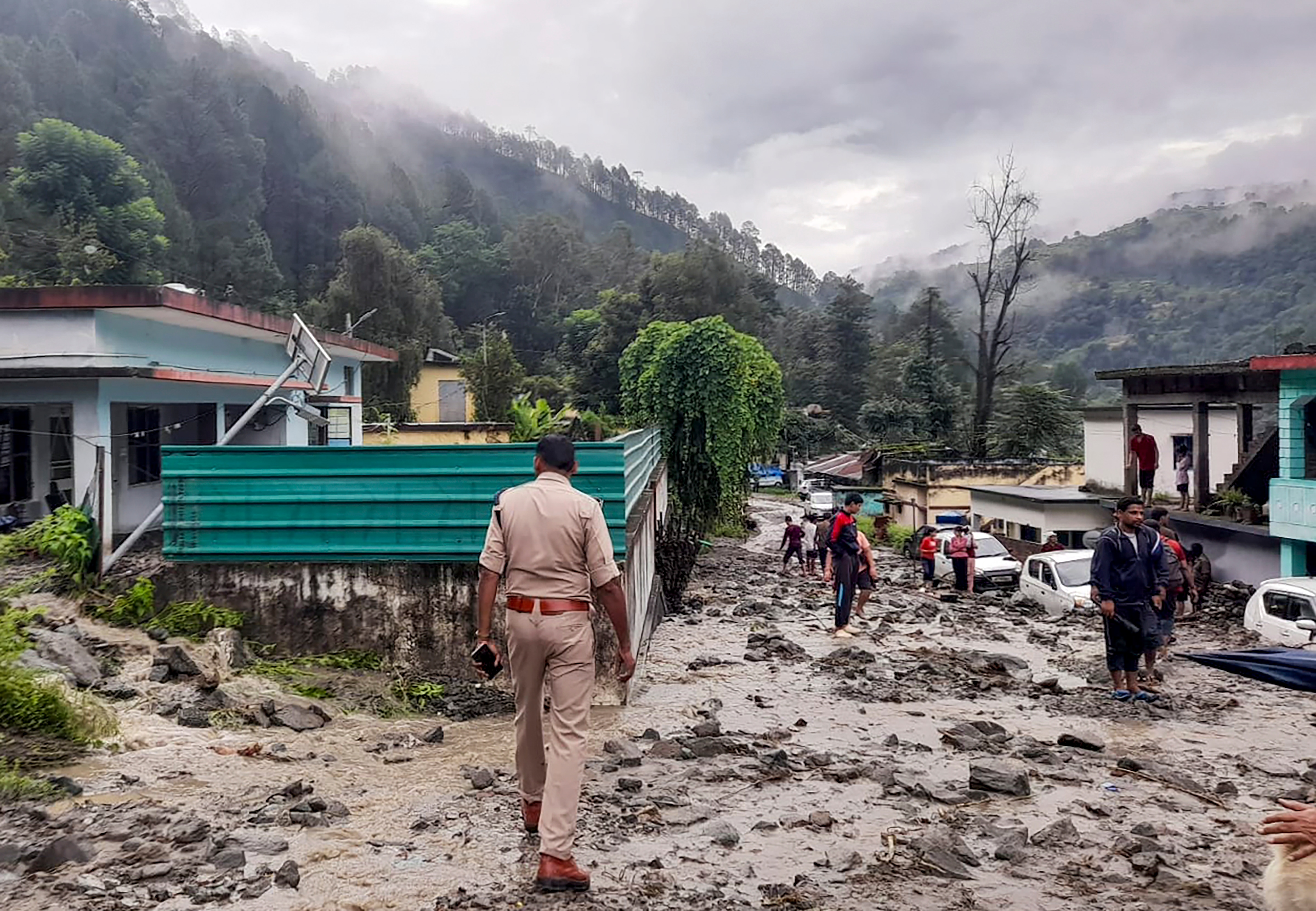 **EDS: THIRD PARTY IMAGE** In this image posted on Aug. 23, 2025, a police official and others during a search and rescue operation at an affected area after heavy rainfall, in Chamoli district, Uttarakhand. (@uttarakhandcops/X via PTI Photo) (PTI08_23_2025_000031A) (@uttarakhandcops) **EDS: THIRD PARTY IMAGE** In this image posted on Aug. 23, 2025, a police official and others during a search and rescue operation at an affected area after heavy rainfall, in Chamoli district, Uttarakhand. (@uttarakhandcops/X via PTI Photo) (PTI08_23_2025_000031A) (@uttarakhandcops)