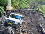 A vehicle being lifted from the debris of a damaged road after heavy rainfall, in Kullu district, on Saturday. (PTI) A vehicle being lifted from the debris of a damaged road after heavy rainfall, in Kullu district, on Saturday. (PTI)