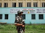 A member of Indian security forces patrols outside Syed Jaffer Memorial School, run by Falah-e-Aam Trust (FAT), an affiliate of Kashmir-based Islamist political party Jamaat-e-Islami (JeI), which was banned. 