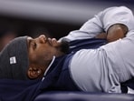 Micah Parsons #11 of the Dallas Cowboys lays on a training table during the second half vs Falcons Micah Parsons #11 of the Dallas Cowboys lays on a training table during the second half vs Falcons