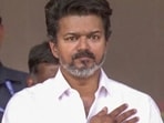Vijay was walking to the stage at the Madurai maanaadu when he noticed a fan dangerously hanging off a railing to meet him. (ANI)