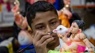 An artisan giving stroking the final touches to a tiny idol of lord Ganesha at a workshop in Parel, ahead of Ganesh Chaturthi celebrations. (Satish Bate/Hindustan Times) An artisan giving stroking the final touches to a tiny idol of lord Ganesha at a workshop in Parel, ahead of Ganesh Chaturthi celebrations. (Satish Bate/Hindustan Times)