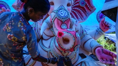An artisan sticks ornaments on an idol of Lord Ganesh in New Delhi's Mayur Vihar, as she completes final touches ahead of Ganesh Chaturthi celebrations. (Salman Ali/PTI) An artisan sticks ornaments on an idol of Lord Ganesh in New Delhi's Mayur Vihar, as she completes final touches ahead of Ganesh Chaturthi celebrations. (Salman Ali/PTI)